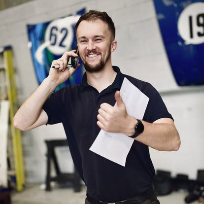 Tom from Coastal Motorsport on the phone in the workshop